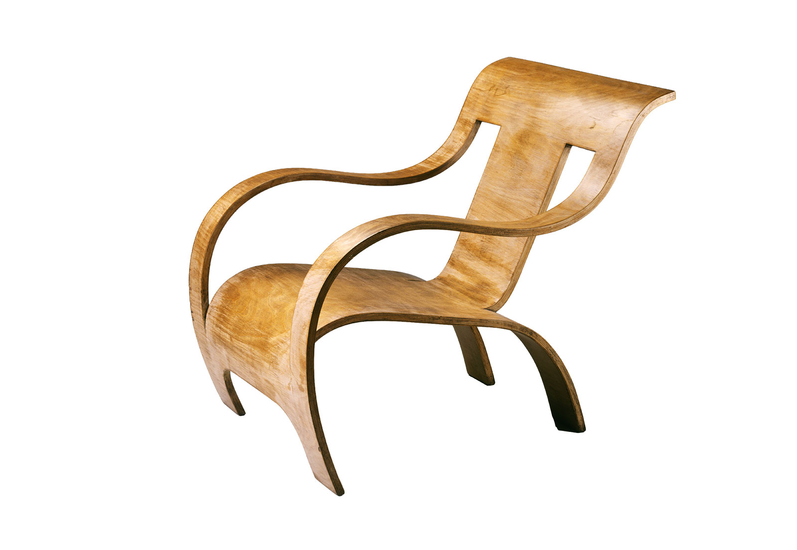 A sculptural wooden armchair made from a single continuous piece of bent plywood, featuring flowing curves that form the backrest, seat, arms, and legs in an unbroken shape