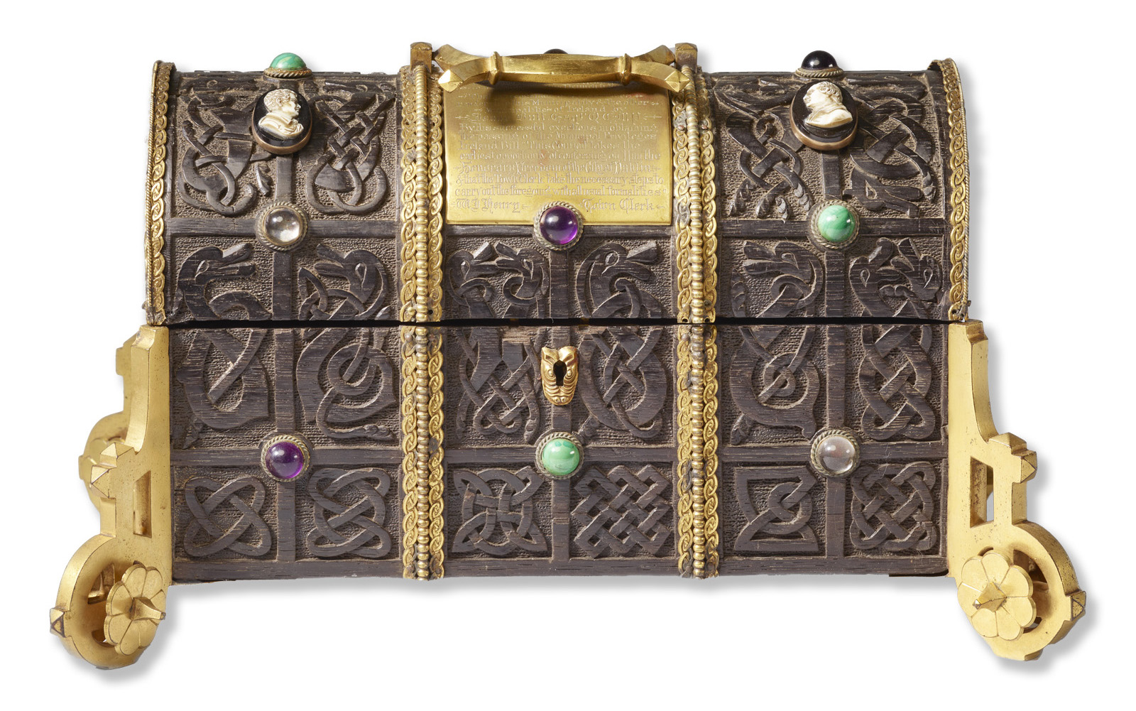 Ornate metal casket with intricate knotwork patterns, gold trim, and decorative gemstones.