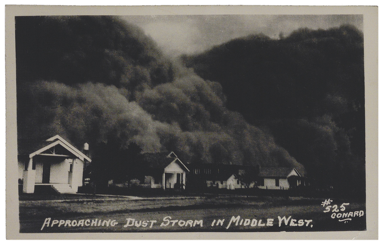 A black-and-white photograph captures a massive dust storm approaching a row of houses. The text reads, "APPROACHING DUST STORM IN MIDDLE WEST."